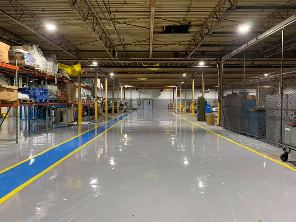 Industrial warehouse epoxy floor coating with safety stripes in Atlanta, GA