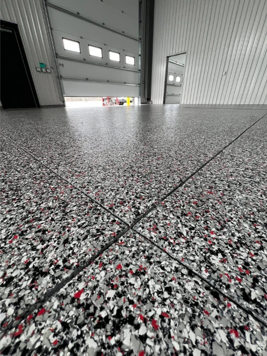 Epoxy garage floor coating with warm-tone flake blend in Peachtree City, GA